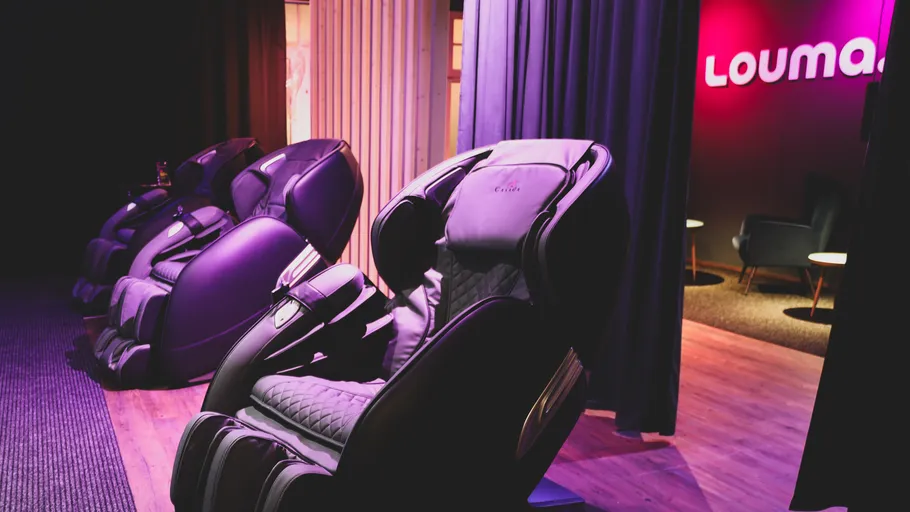 Massage chairs in a dimly lit room.