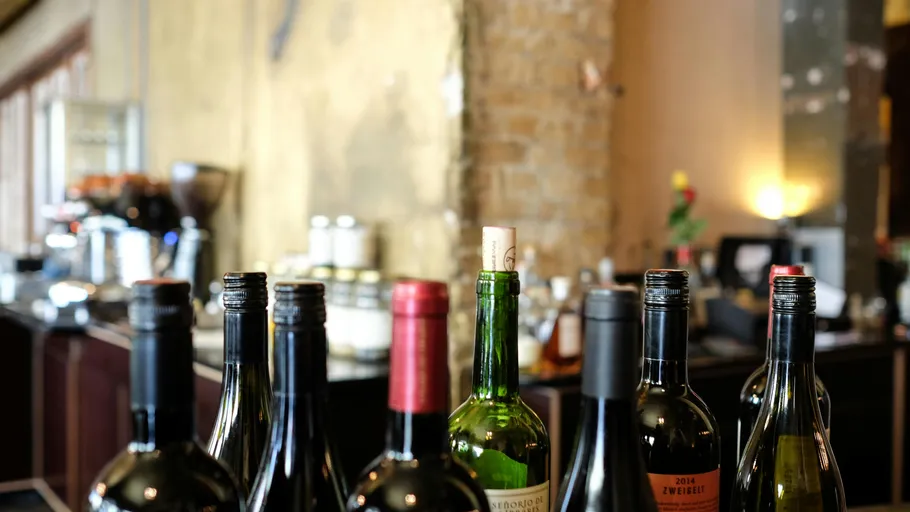 Wine bottles displayed on a restaurant counter.