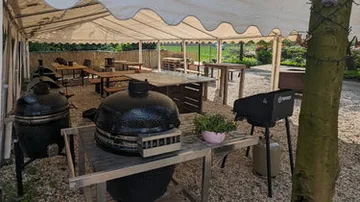 Outdoor dining area with covered seating and grills.