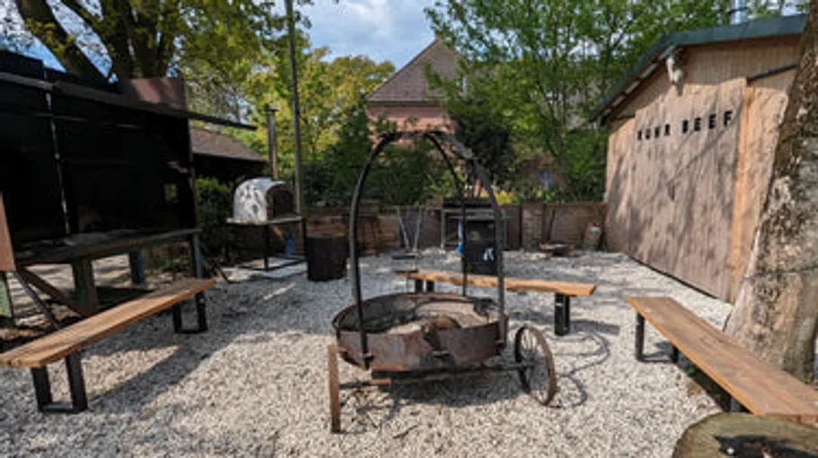 Outdoor fire pit surrounded by benches.