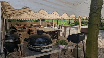 Outdoor canopies with grills and tables