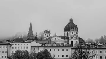 Historic buildings in foggy cityscape.