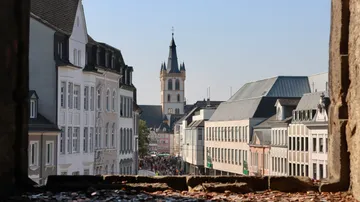 View of street and church steeple through window.