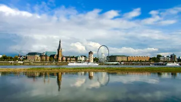 City skyline with church and Ferris wheel.