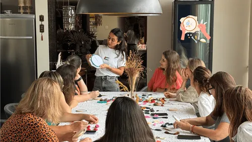 Group embroidery lesson happening in a kitchen.
