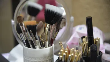 Makeup brushes and tools on a vanity.