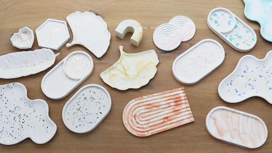 Assorted decorative trays on wooden surface.