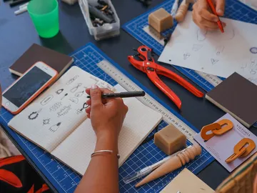 Sketchbook is described; creative work at the table.