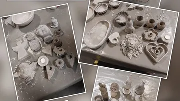 Various plaster molds and sculptures on a table.