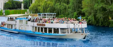 Tour boat sailing on a blue river.