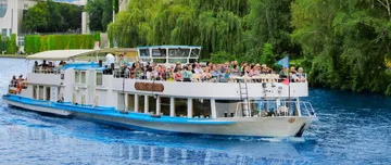 Tour boat filled with passengers on river.