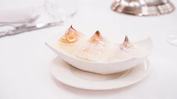 Dessert with peaks on white dish and table.