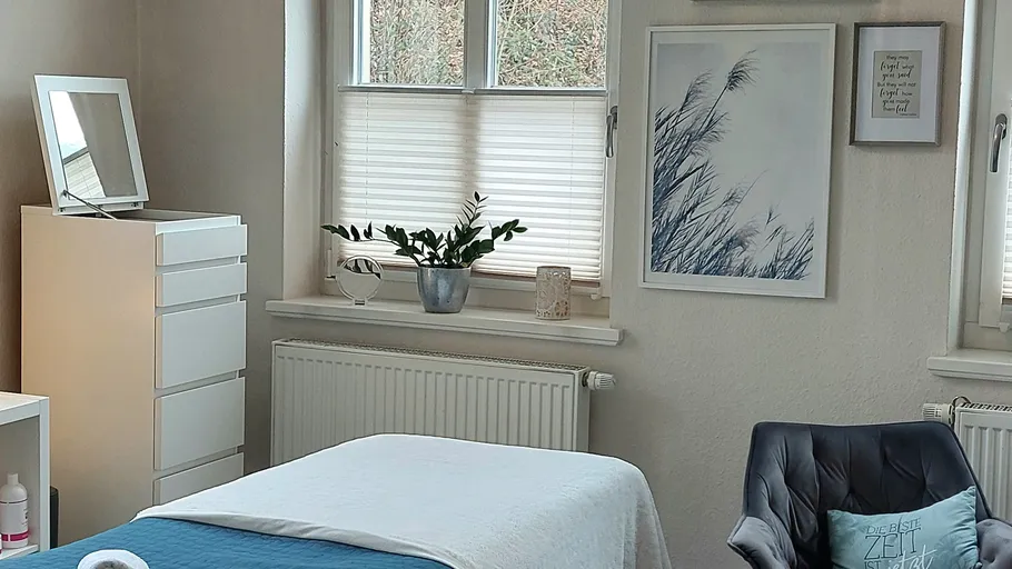 Spa room with treatment table and decor.