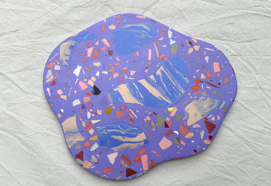 Purple abstract art piece with colorful shapes.