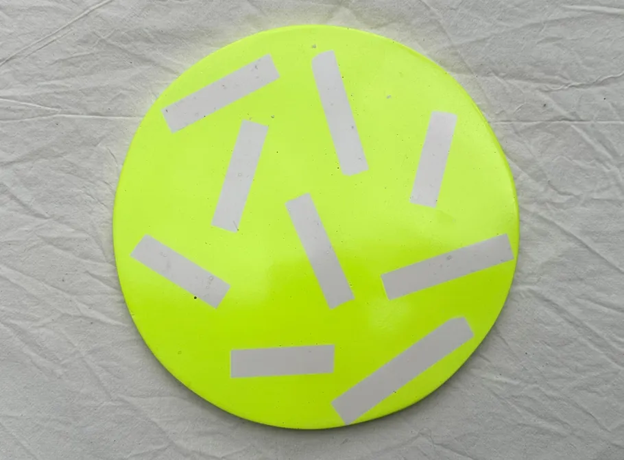 Yellow disc with reflective strips on cloth.