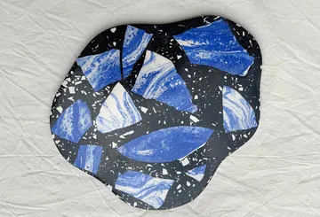 Blue and black terrazzo pattern on white background.