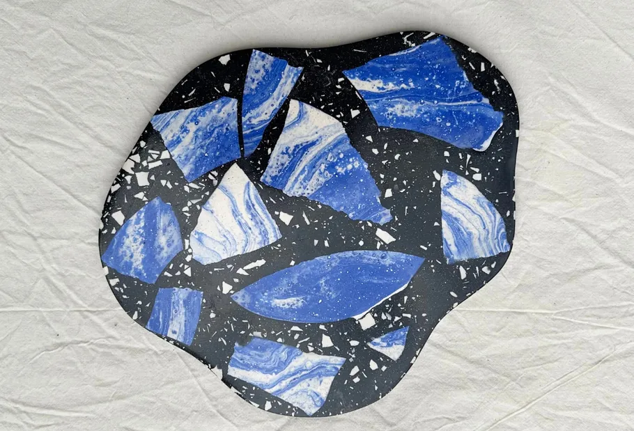 Blue and black terrazzo pattern on white background.