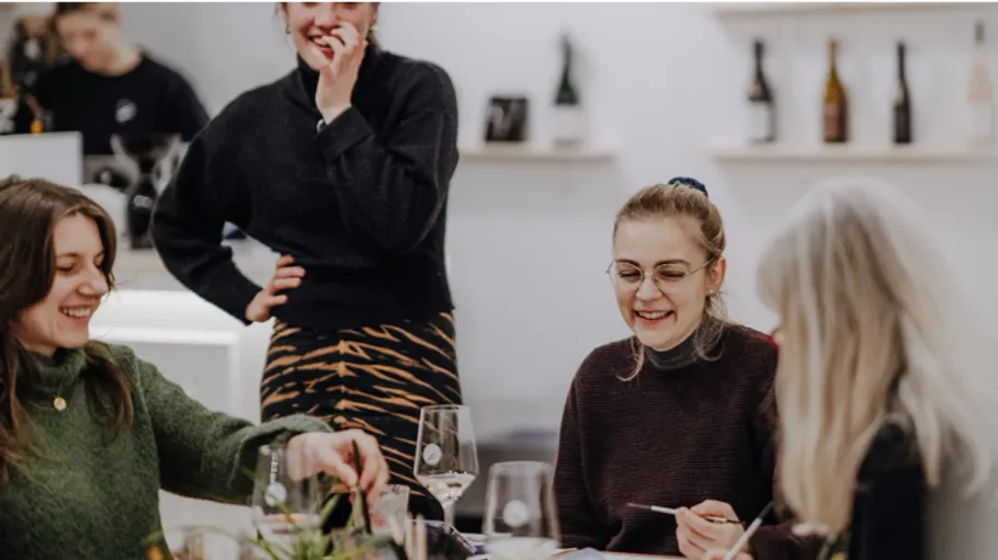 People smiling and dining in a cozy restaurant.