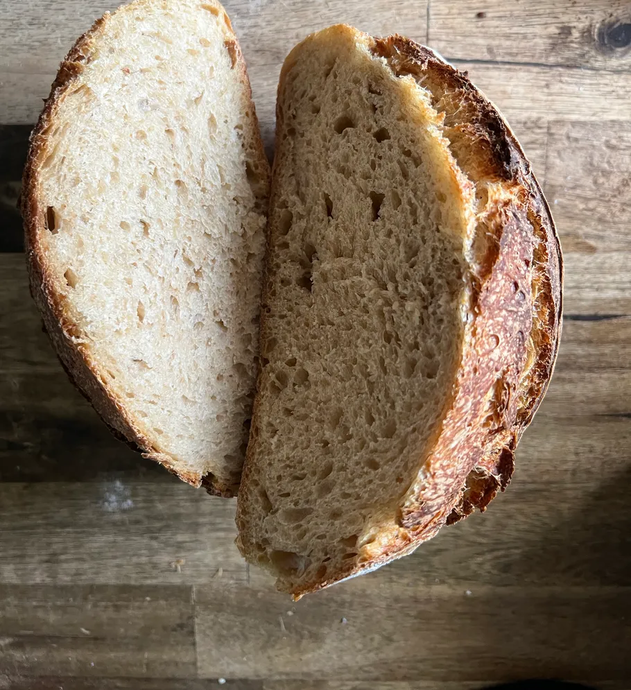 Two bread slices on a wooden table.