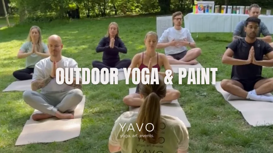 People practicing yoga outdoors on mats.
