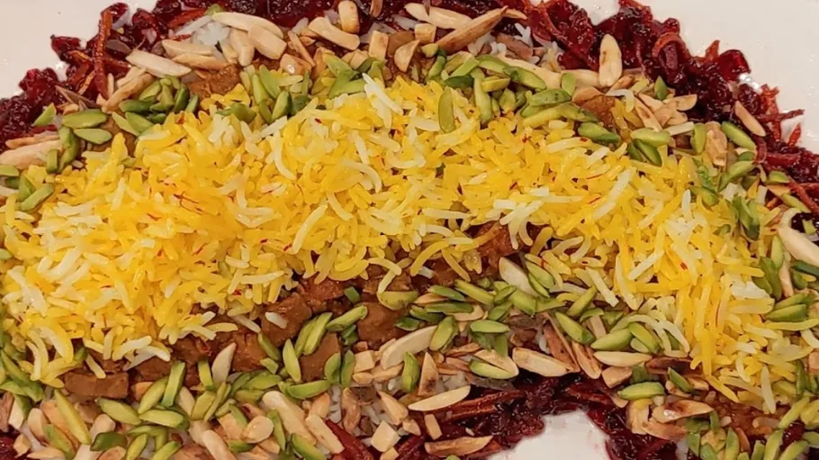 Colorful rice dish with nuts and vegetables.