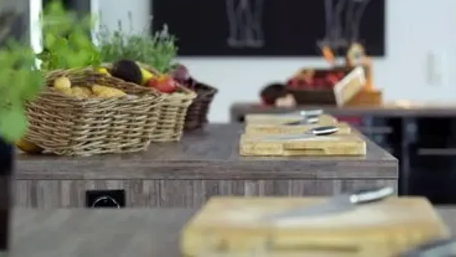 Chopping boards with knives on kitchen counter.