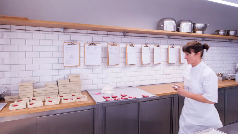 Woman preparing chocolates in a kitchen.