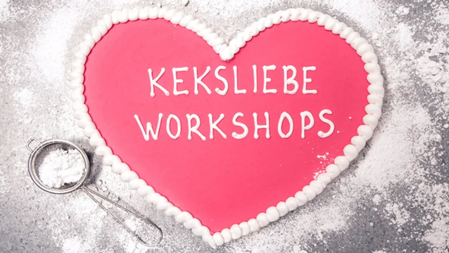 Heart-shaped cookie with text, powdered sugar nearby.