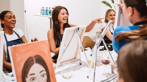 People laughing at a painting class.