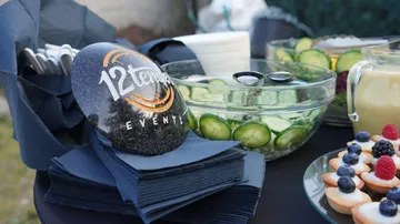 Party table with food and branded rock.