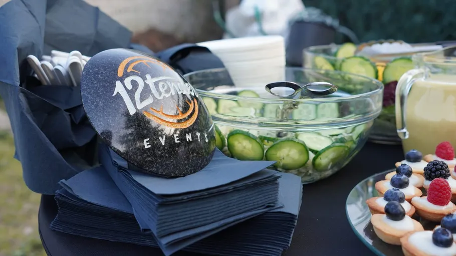 Party table with food and branded rock.