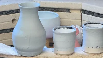 Pottery items inside a kiln during firing.