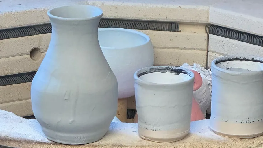 Pottery items inside a kiln during firing.
