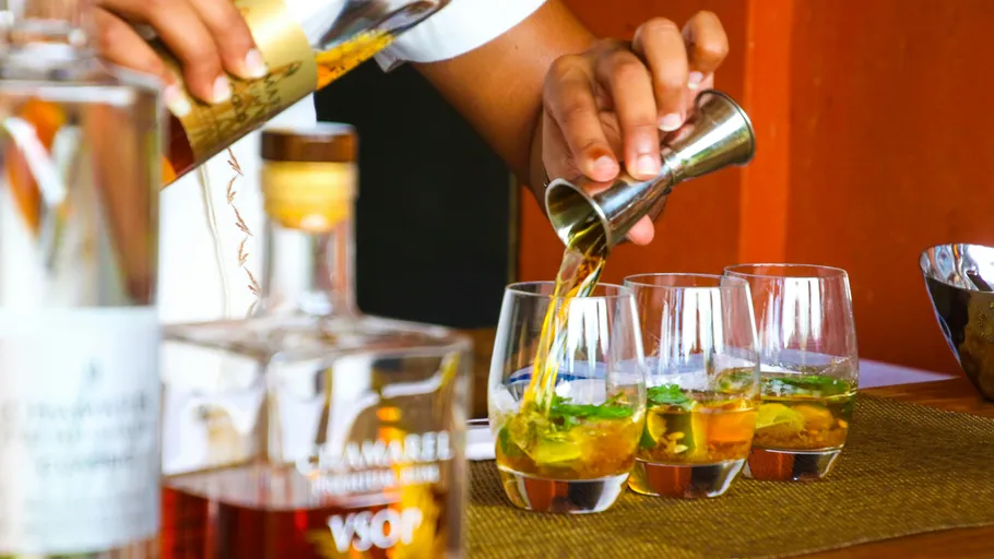 Bartender pouring drinks at a bar.