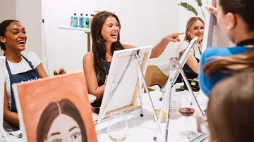 Women enjoying a painting class together.