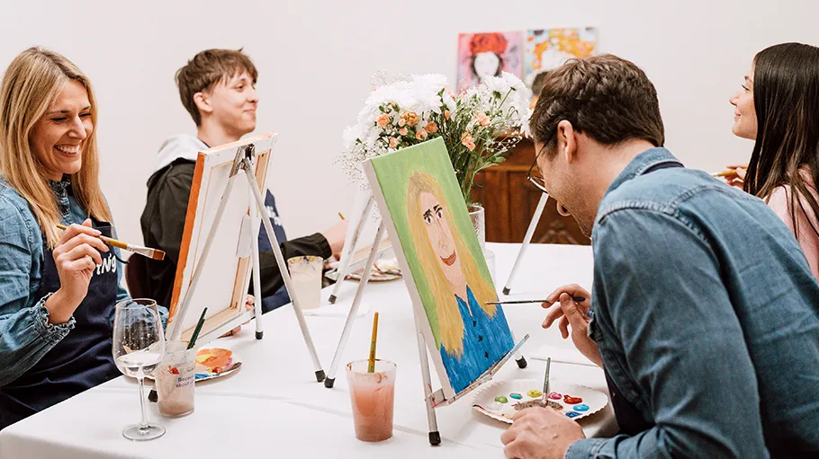 Group painting together at a table.