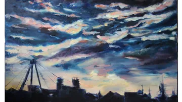 Colorful clouds over city silhouette at dusk.