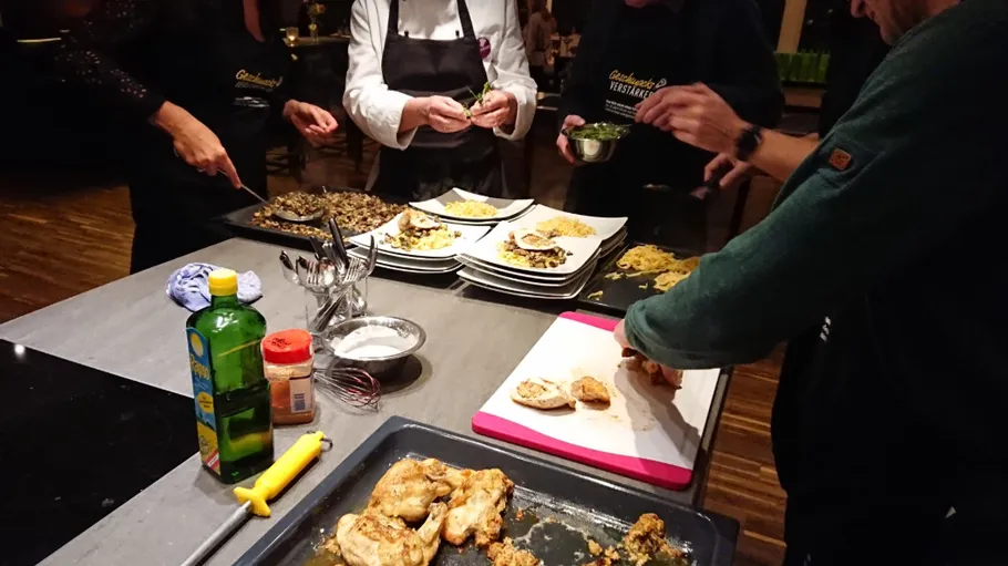 People preparing gourmet dishes in kitchen.