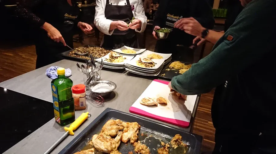 People preparing food at kitchen counter.