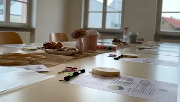Craft supplies and instructions on tables.