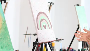 Paintings on easels in art studio.