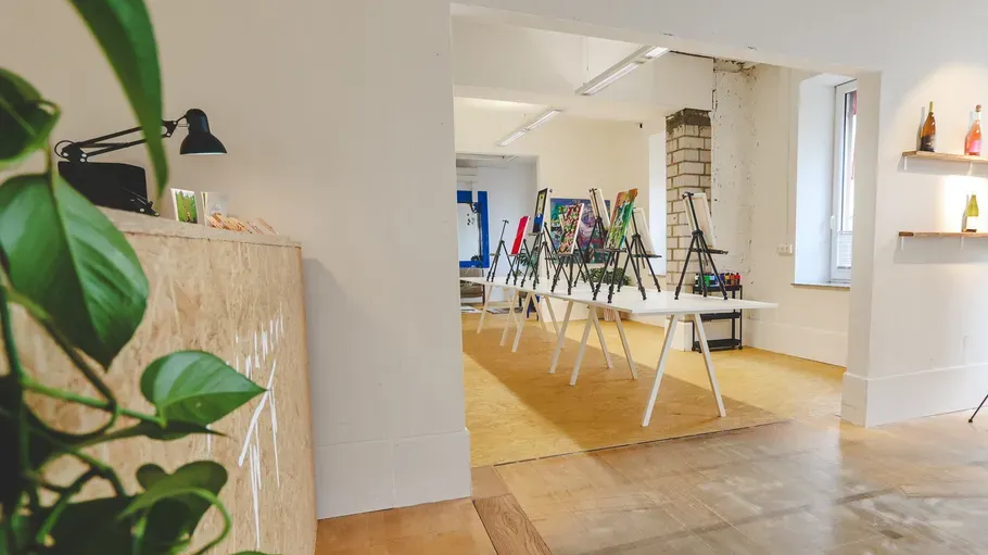 Art studio with easels on tables.