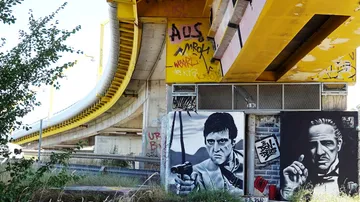 Graffiti under bridge featuring iconic film characters.