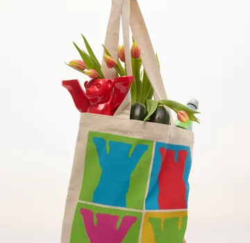 Colorful bag with tulips and a red bear.