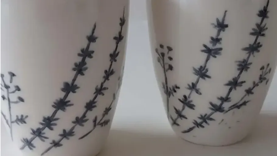 Two ceramic mugs with blue floral design.