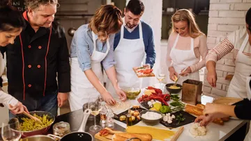 Group cooking in a bright kitchen.