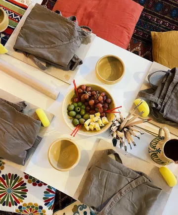 Bastelbedarf und Snacks auf buntem Tisch.