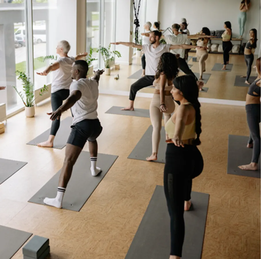 People practicing yoga in a bright studio.