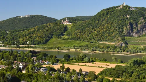 Castle on hill above river and village.