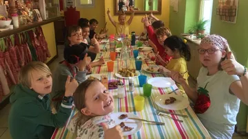 Children eating together at a colorful table.